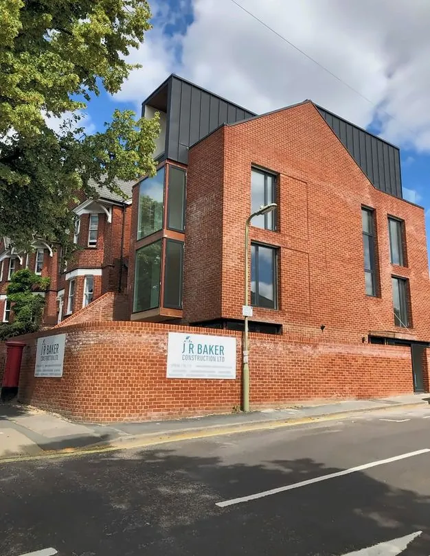 Pair of new red-brick houses with dark cladding, Winchester