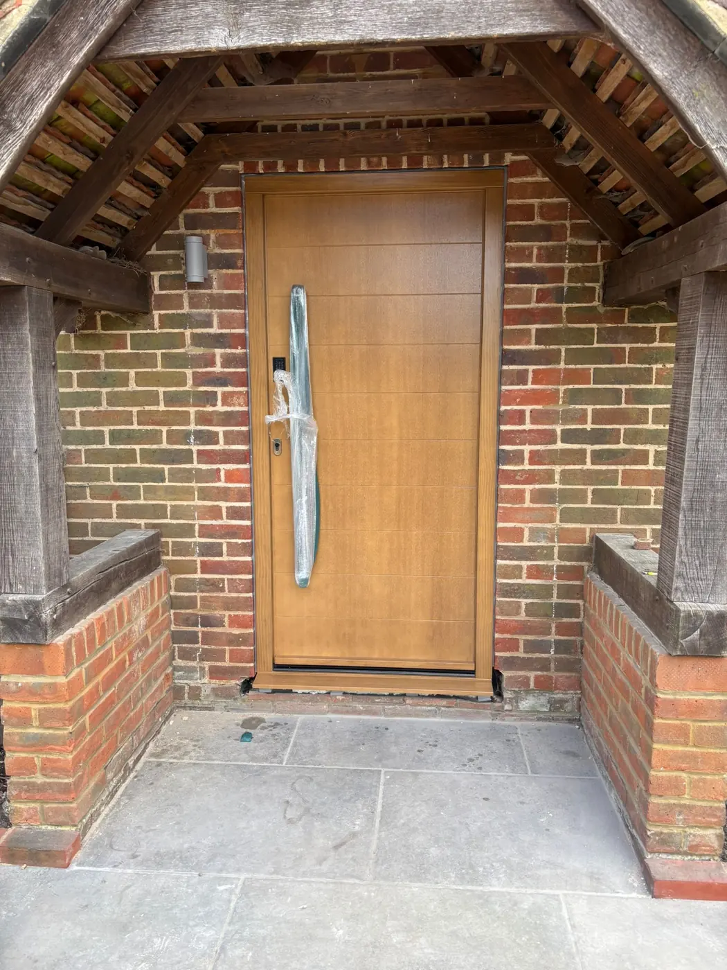 New oak front door set within the original brick porch