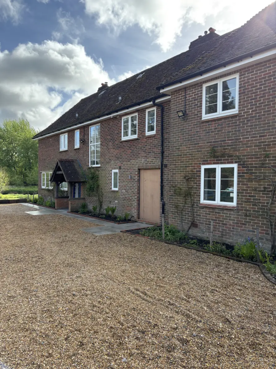 The farmhouse from the front, across a new gravel drive