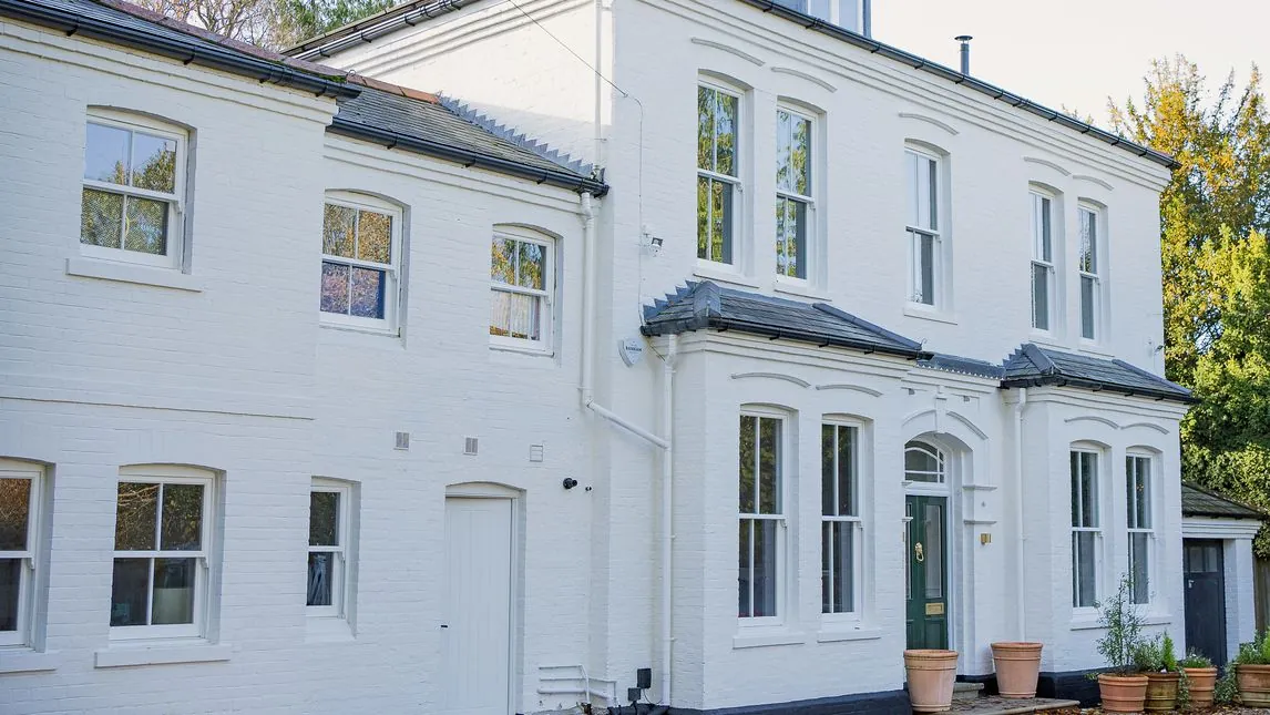 Front of the refurbished white-painted period house with sash windows