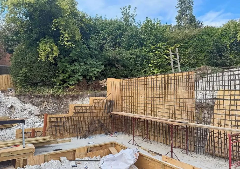 Reinforcement and timber formwork for a retaining wall on a sloping site