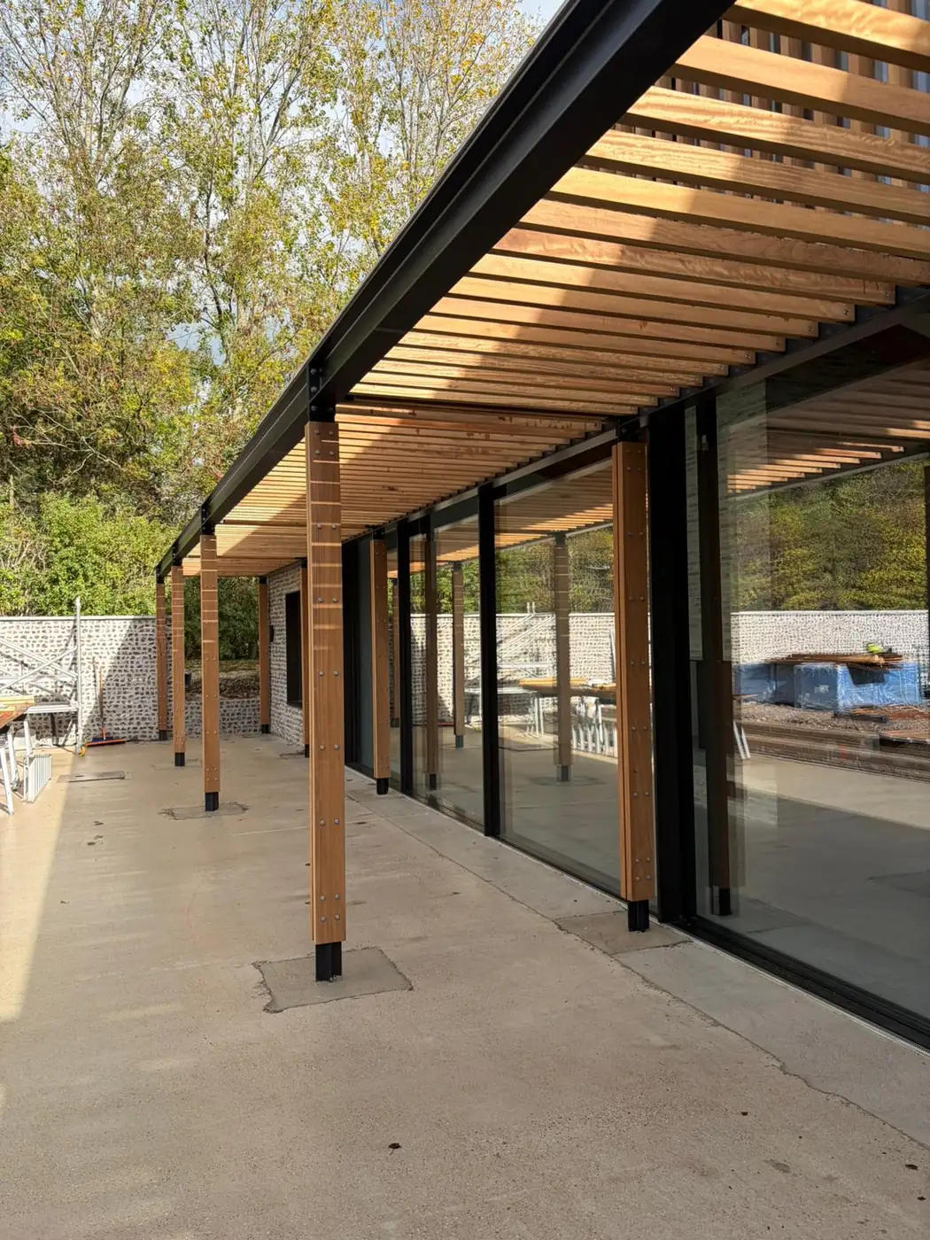 Looking along the colonnade, with timber posts and exposed rafters over the terrace